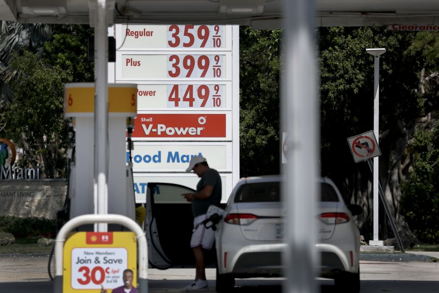 El precio por litro de gasolina se muestra en un letrero mientras un cliente compra gasolina en una estación el 9 de marzo de 2026 en Miami.